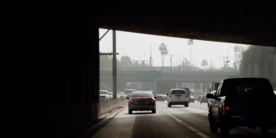 Cars and trucks driving in a busy highway