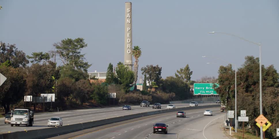 Vehicles are driving on a divided highway in spring