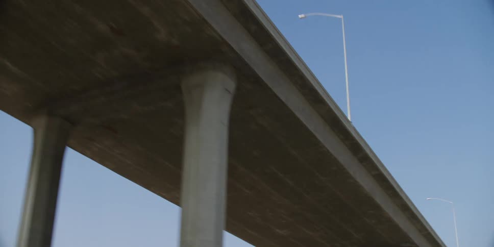 A highway exit ramp on columns on a bright day