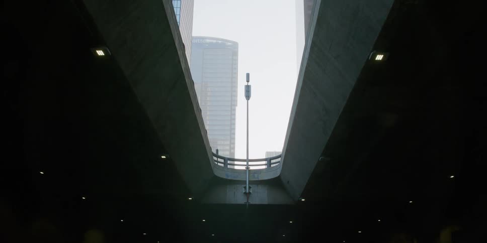 High rise office buildings seen from the top of a tunnel