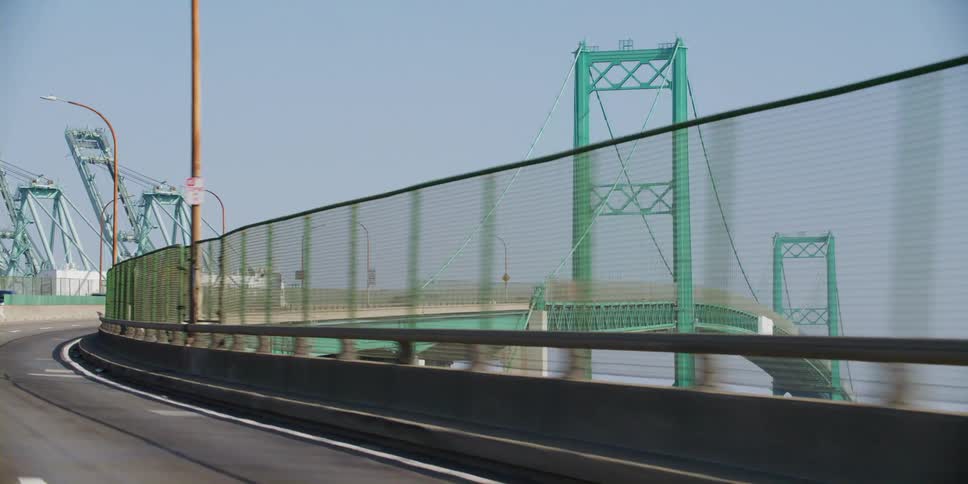 Vehicles are driving on a bridge in a spring