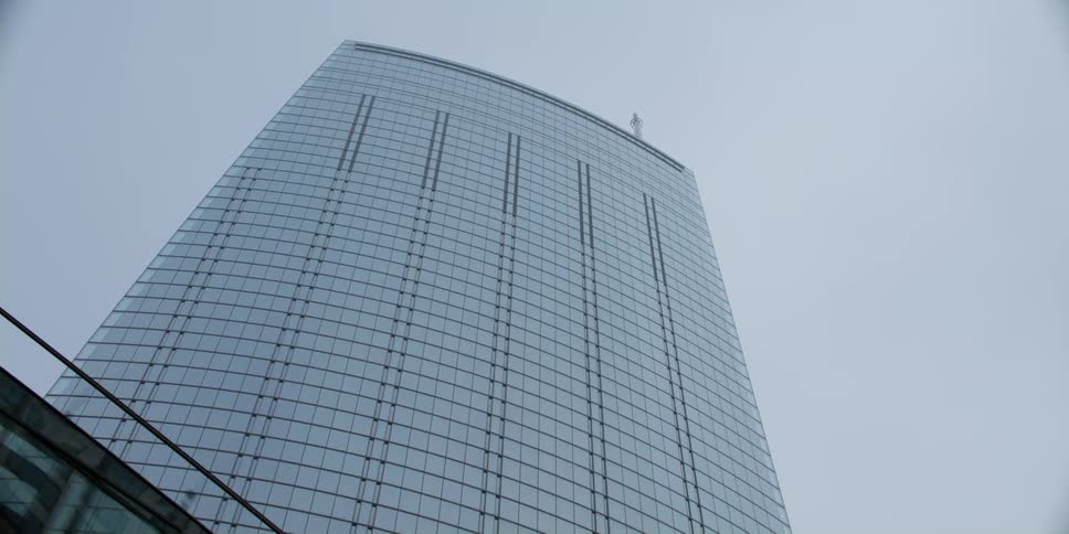 Looking up at a tall skyscraper high in the sky