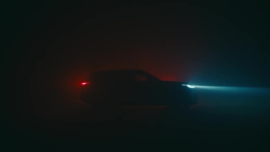 A car is parked in a parking lot at night