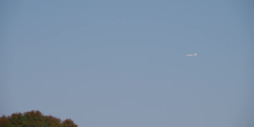 The plane is traveling in the clear sky