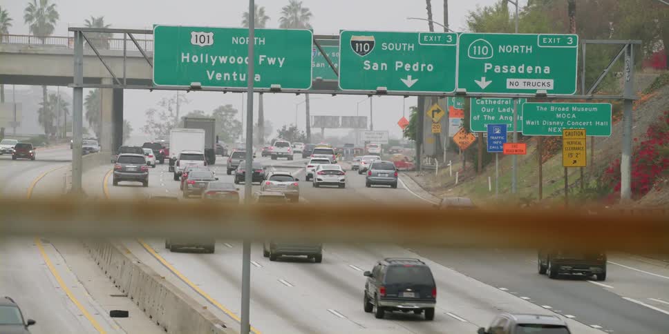 Cars are driving on a highway during spring