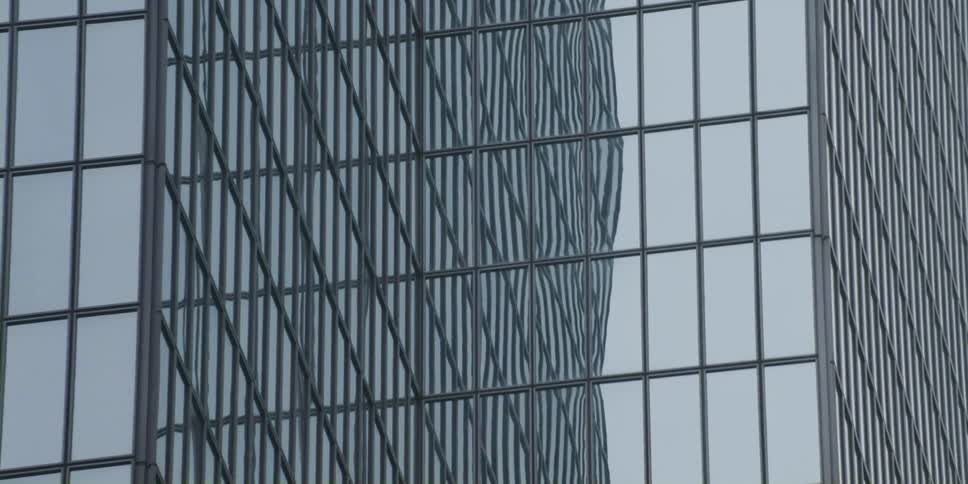 Glass on skyscraper reflects sky