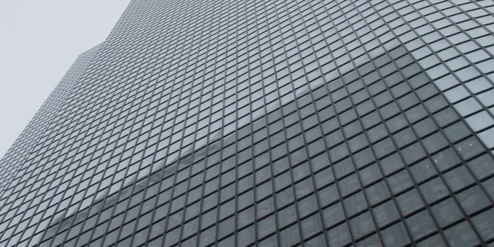 Aerial view of a tall building in a city is displayed