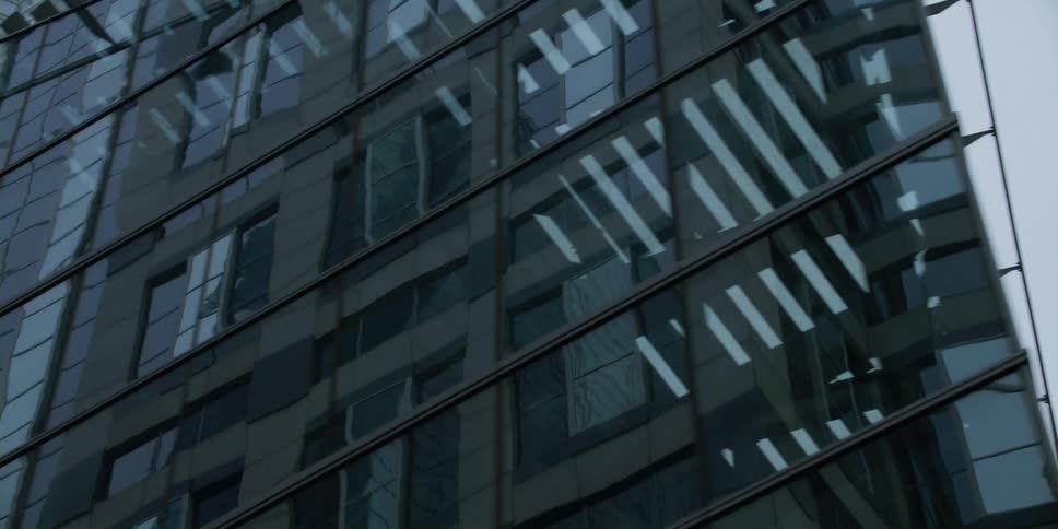 A tall building in a city is displayed