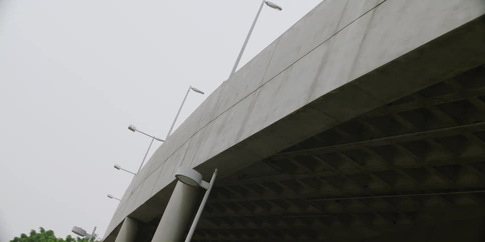 A hydraulic lift sits on a bridge under construction