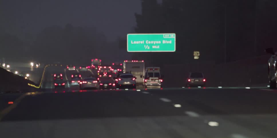 Traffic moves on the highway at night