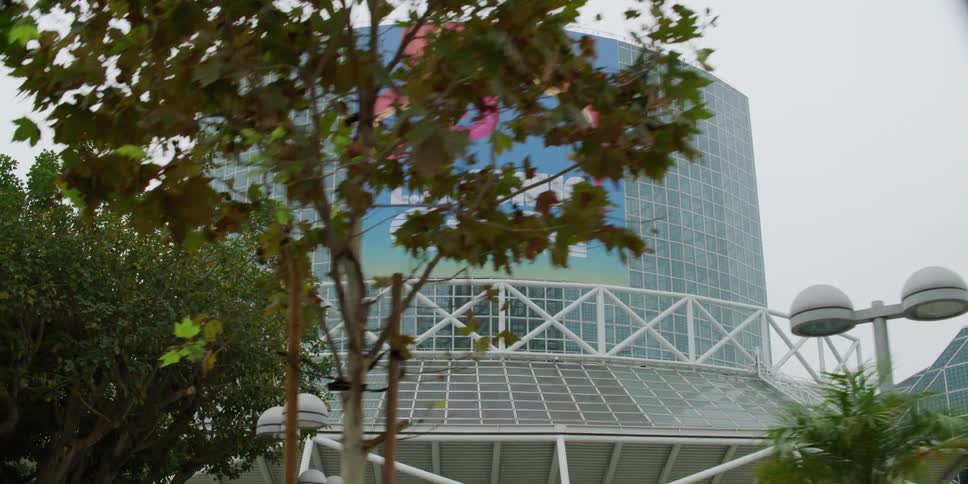 A banner outside a convention center advertises for a comic convention