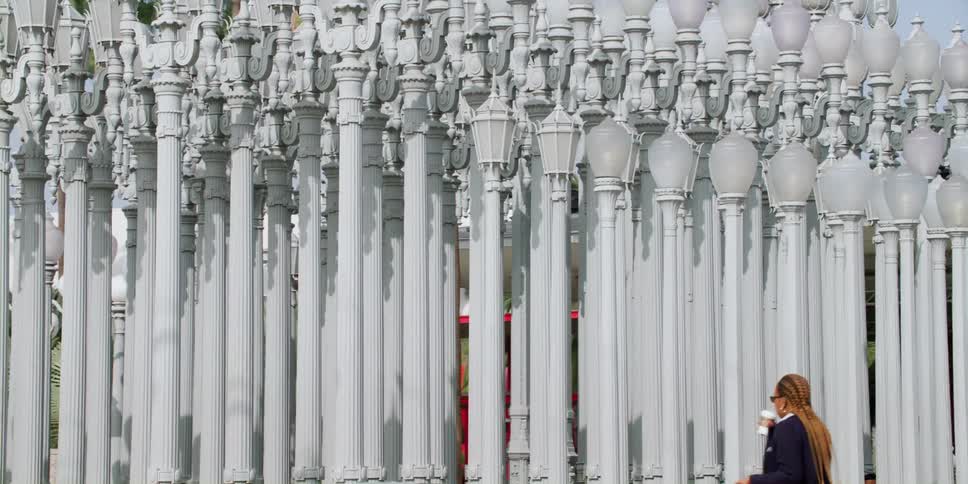 People walk past the collection of lamp posts