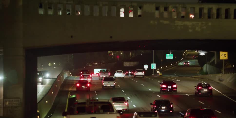 The traffic is moving at night on the freeway