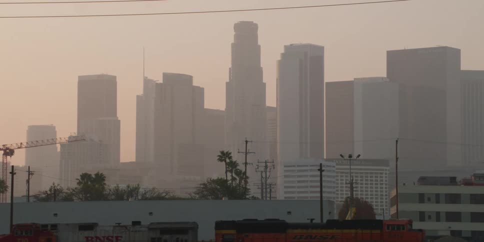 A city skyline is seen through the fog