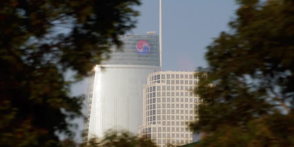 The sun reflects off the large building