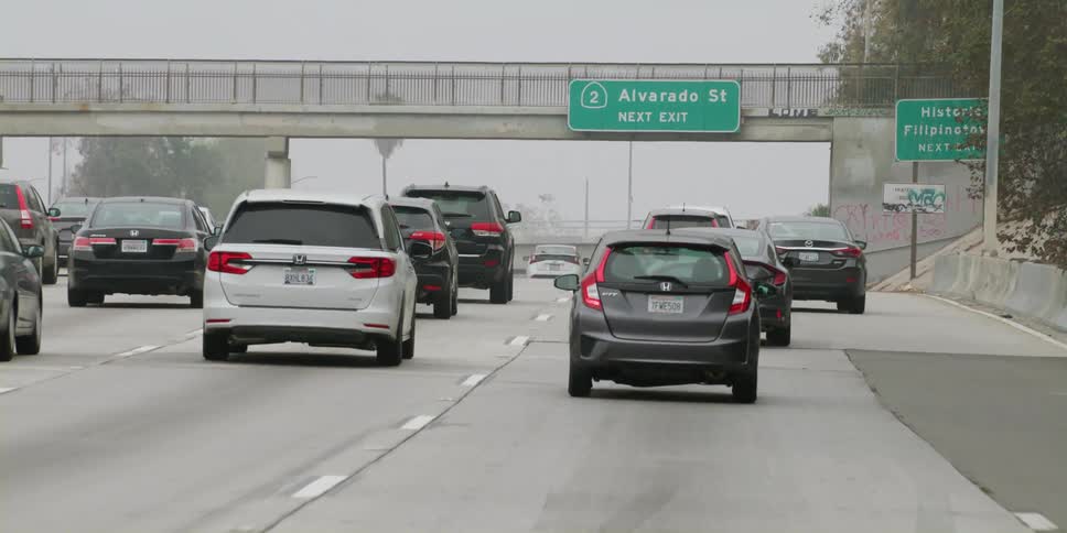 Cars change lanes in traffic
