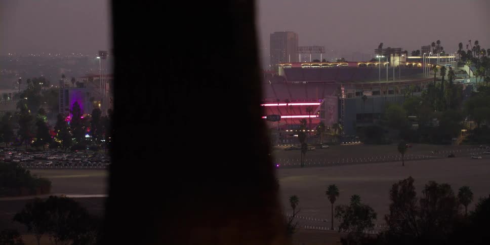 A stadium in a city is displayed at night