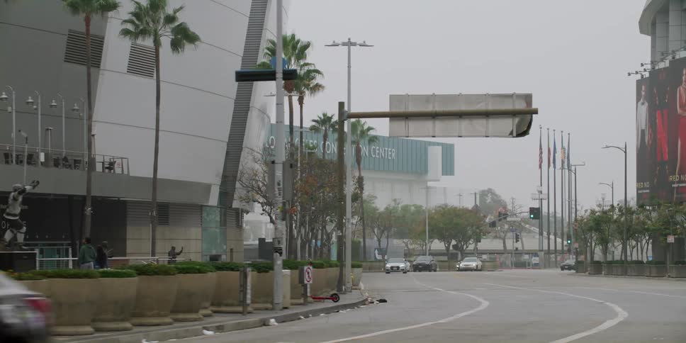 Cars are driving through a downtown city in spring