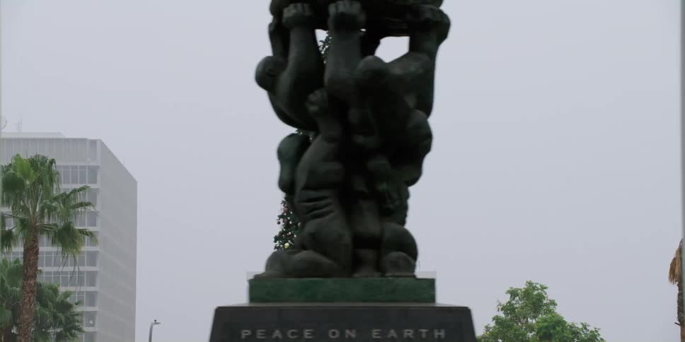 Statues are shown in a downtown city