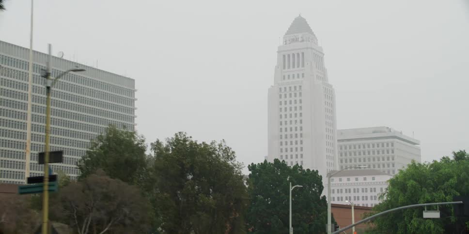 Cars are driving through a city in spring