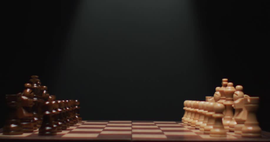 Chess pieces sit on their respective ends on a chess board