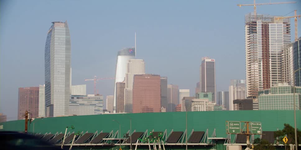 Cars are driving on a highway in a city