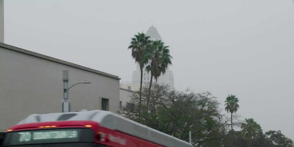 A bus on a city street in front of buildings