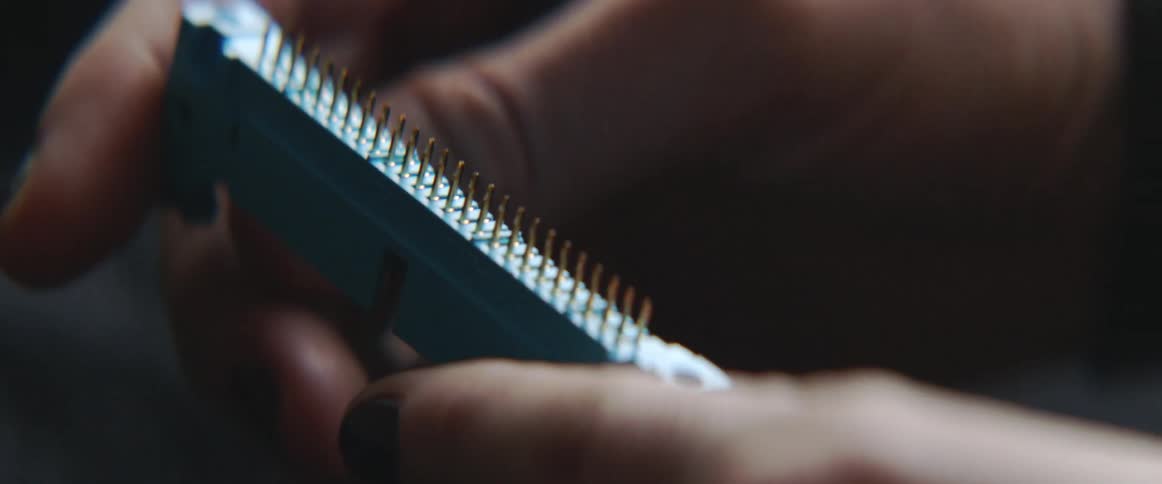 Someone is holding an electronic component in their hand