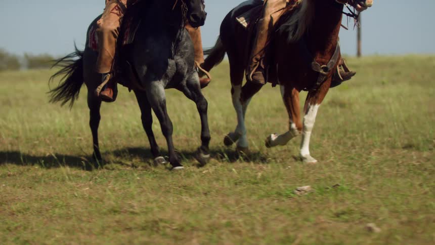 Two people are horseback riding