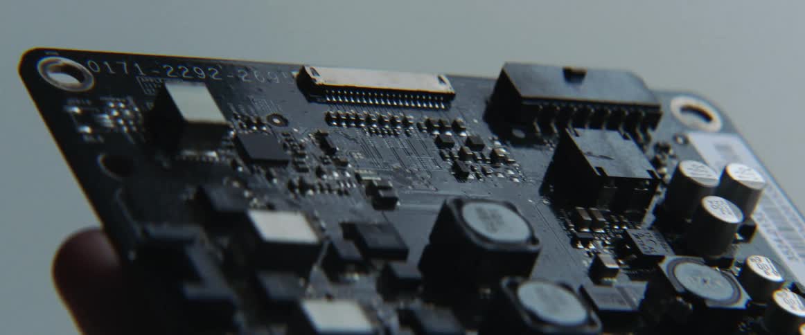 A person is holding a computer board