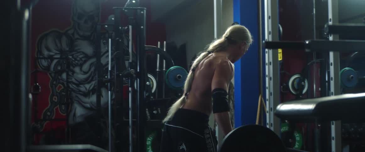 A man is lifting weights in the gym