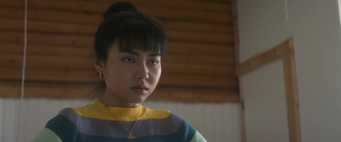 Teenager asian girl standing in her bedroom alone with a sad and distressed facial expression