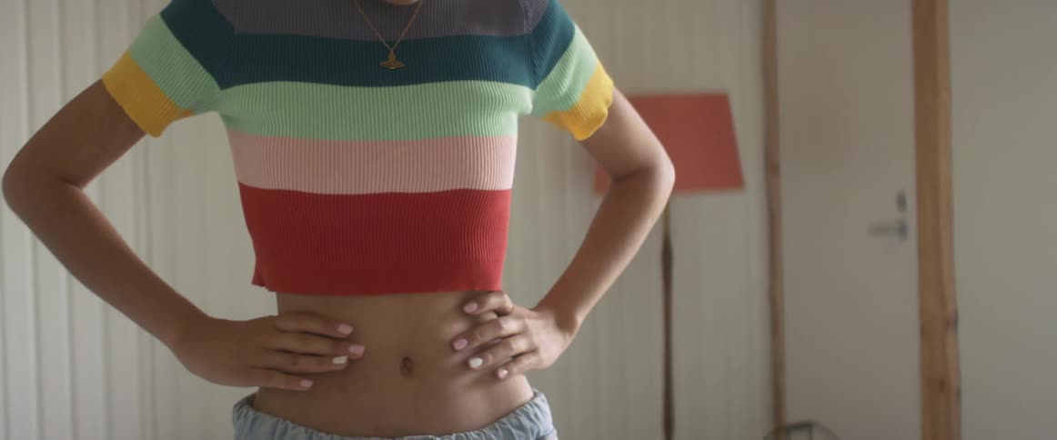 A girl squeezes her sides