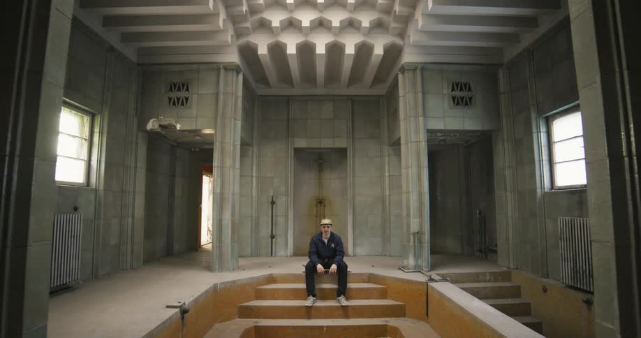 A man is sitting still in the building