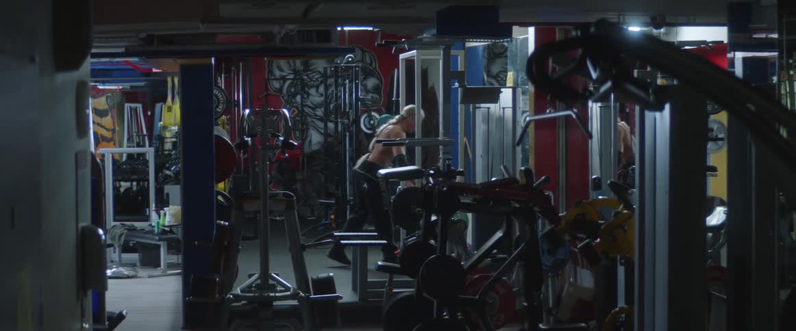A man lifts weights indoors