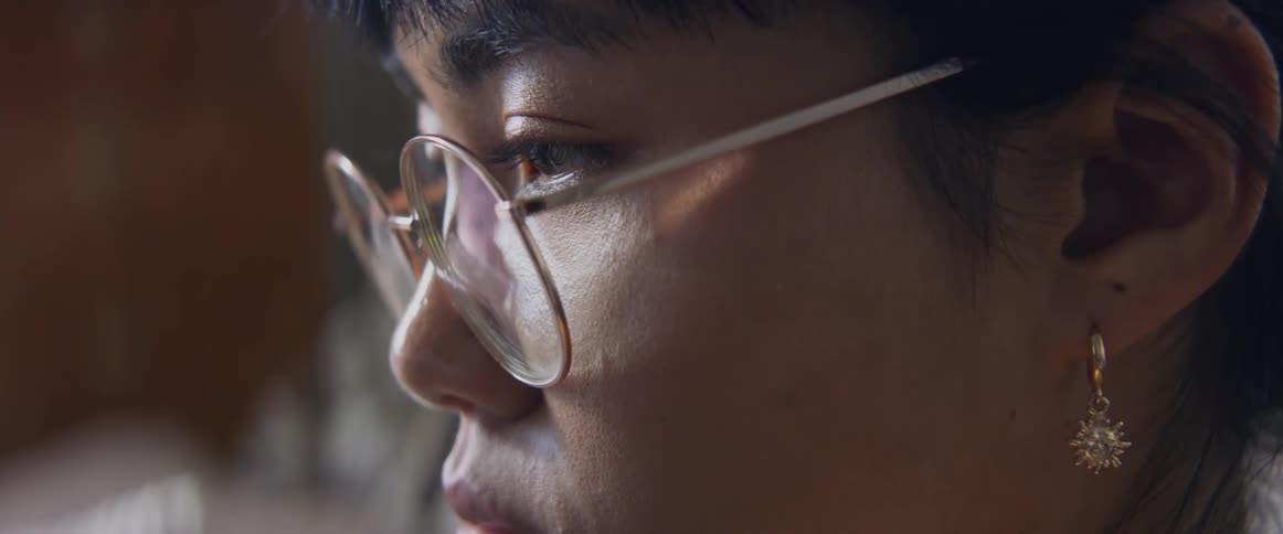 A woman blinks as she concentrates