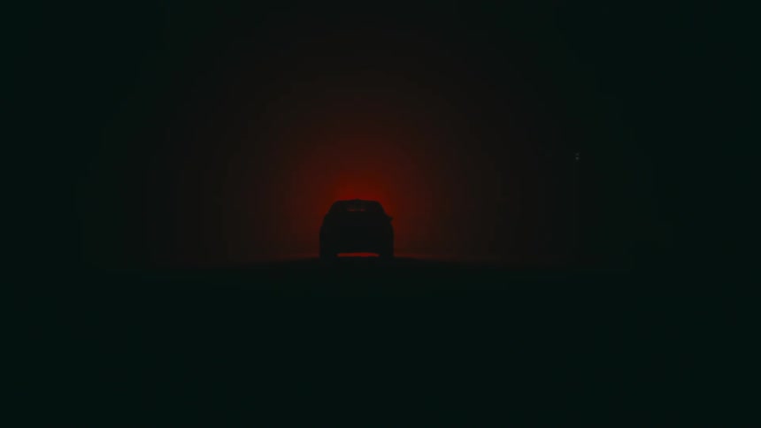 A passenger steps into a vehicle at night