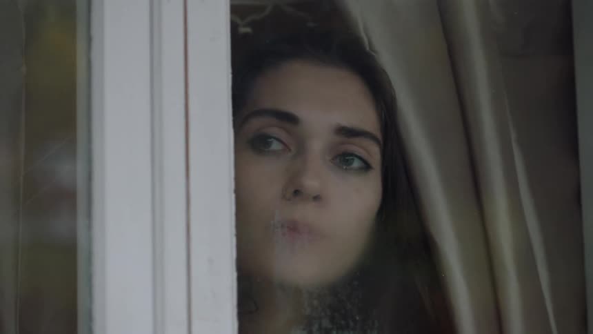 Woman looking out a window