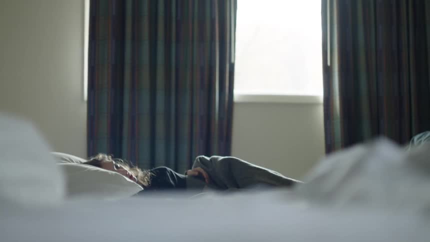 A woman laying down in bed