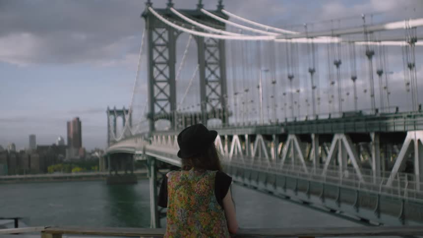 A person looking at a bridge
