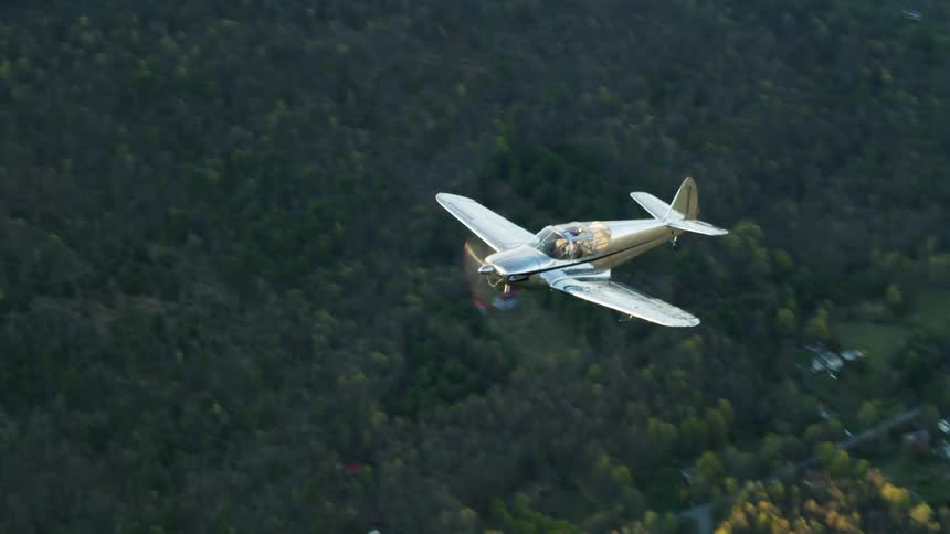 A plane is flying over the rural area