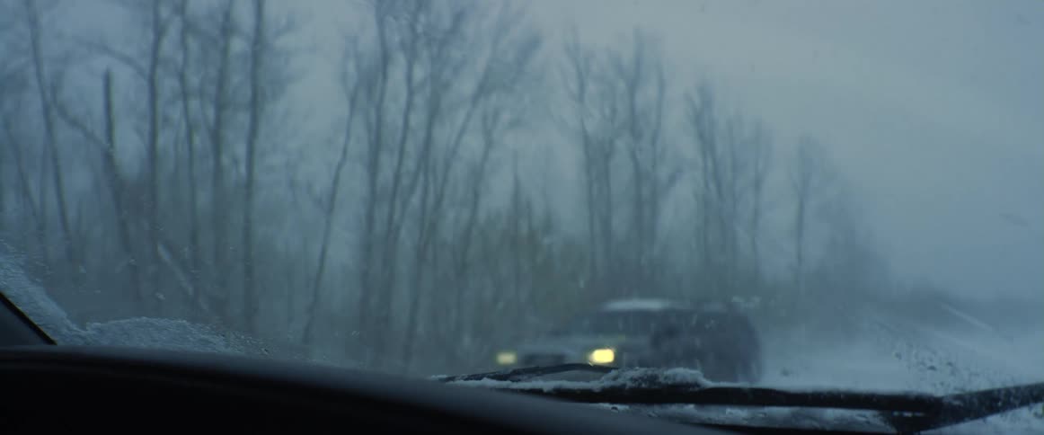 Cars driving during a snow storm