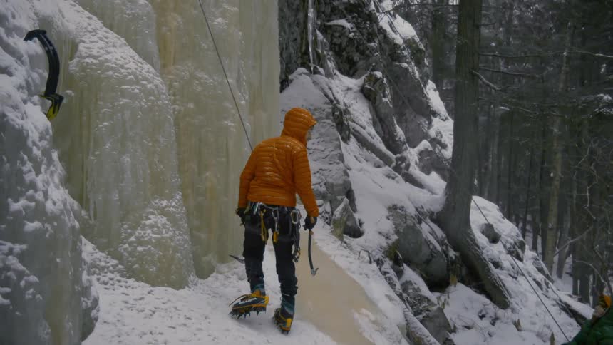 A person begins climbing the cliff