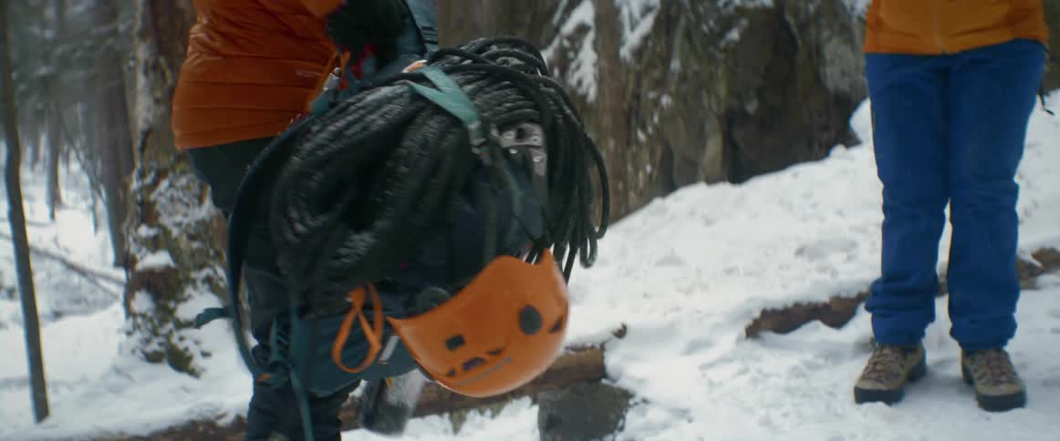 Two people carry their equipment to go rock climbing