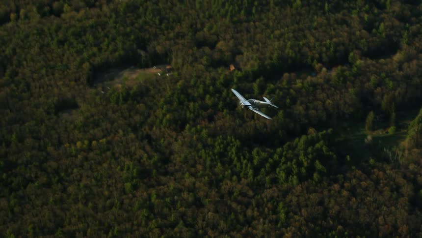 An aerial view of a plane flying outdoors