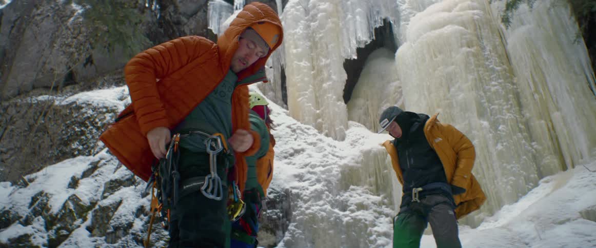 Three men put on their rock climbing gear