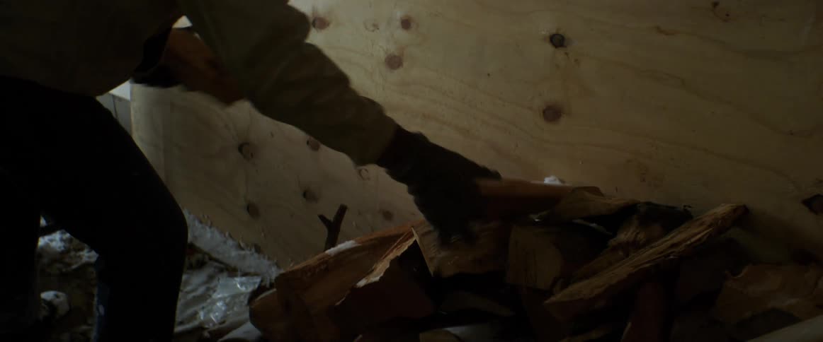 Man wearing coat moved chopped fire wood