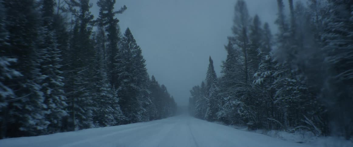 A vehicle drives on the trail during the storm
