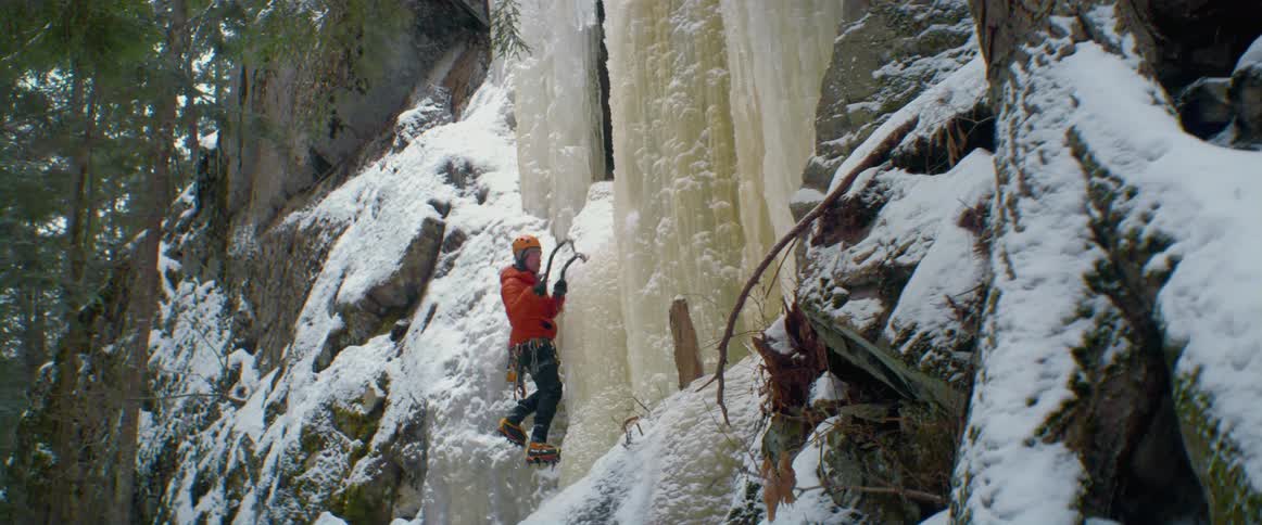 A view of a person climbing a wall of ice