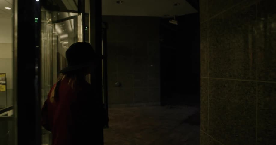 A woman walking through a revolving door